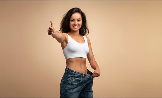 Woman showing loose jeans