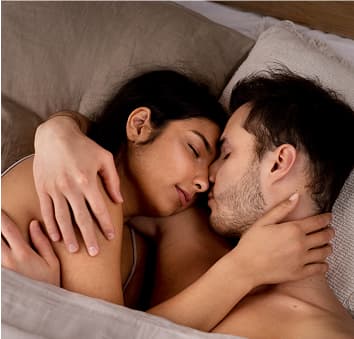 Couple kissing in bed